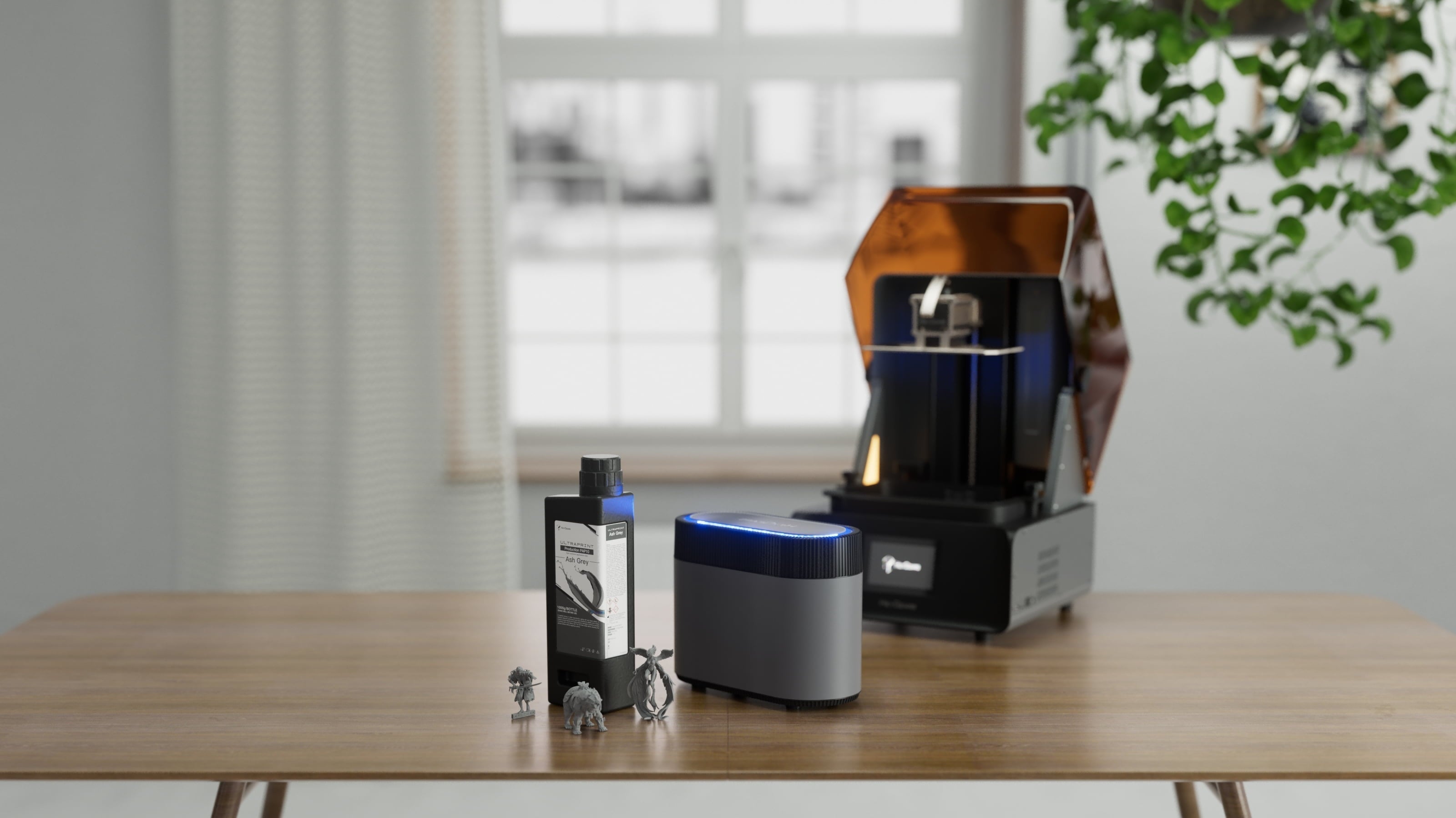 HeyGears resin 3D printer with resin bottle, curing unit, and miniature models on a table.