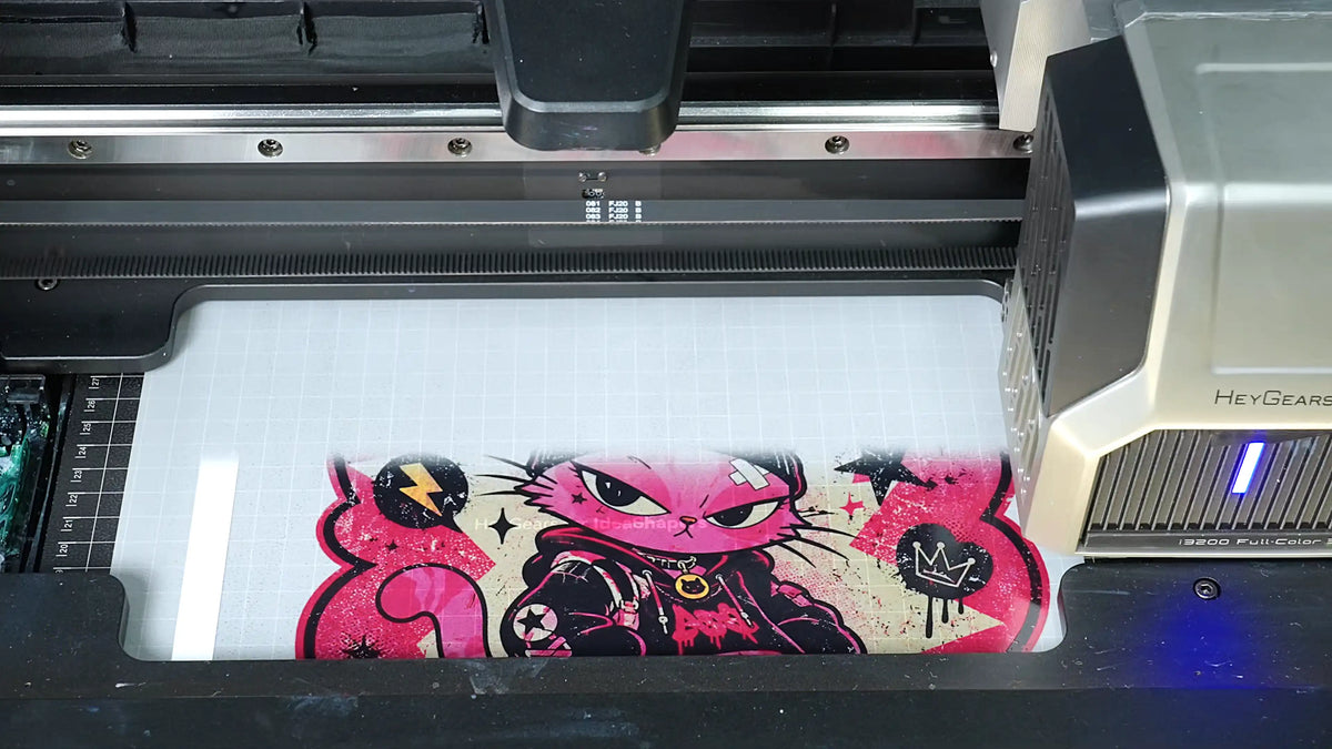 HeyGears G1X printing a full-color design onto DTF transfer film for custom apparel decoration.