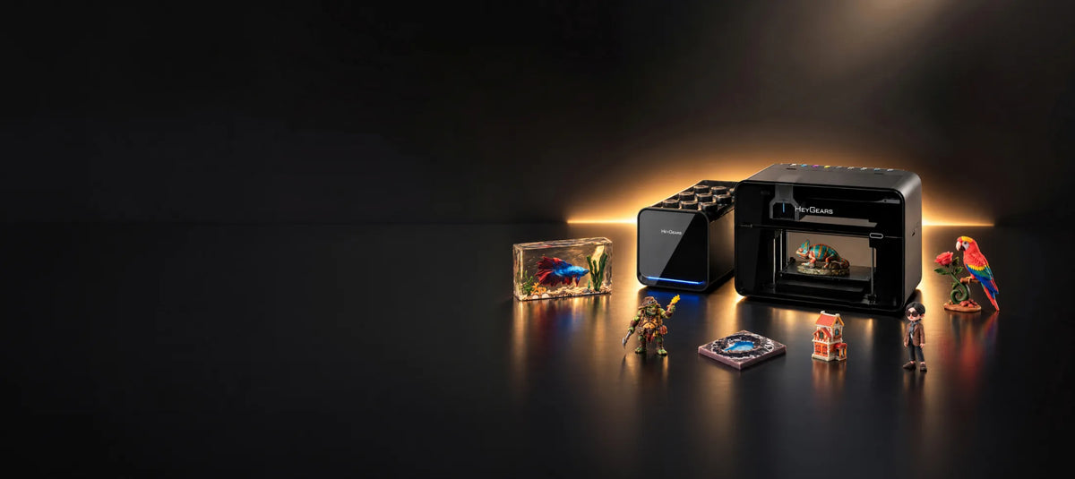 HeyGears G1X 3D Edition full-color 3D printer displayed with vibrant 3D-printed models, including a chameleon, parrot, miniature house, and figurines, showcasing creative full-color 3D printing.