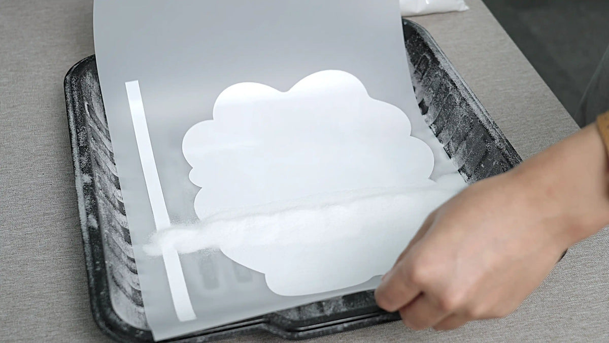 Applying hot-melt powder evenly to printed DTF transfer film for strong adhesion before heat transfer with HeyGears G1X.