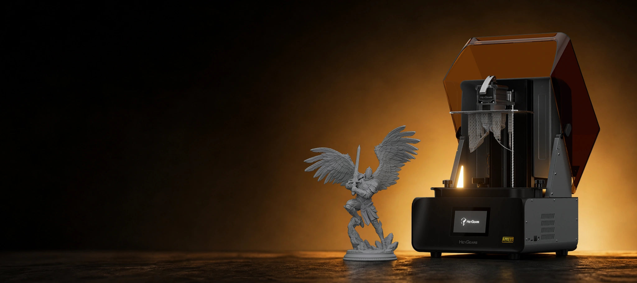 HeyGears RS Turbo resin 3D printer beside a detailed winged miniature for precision home 3D printing.